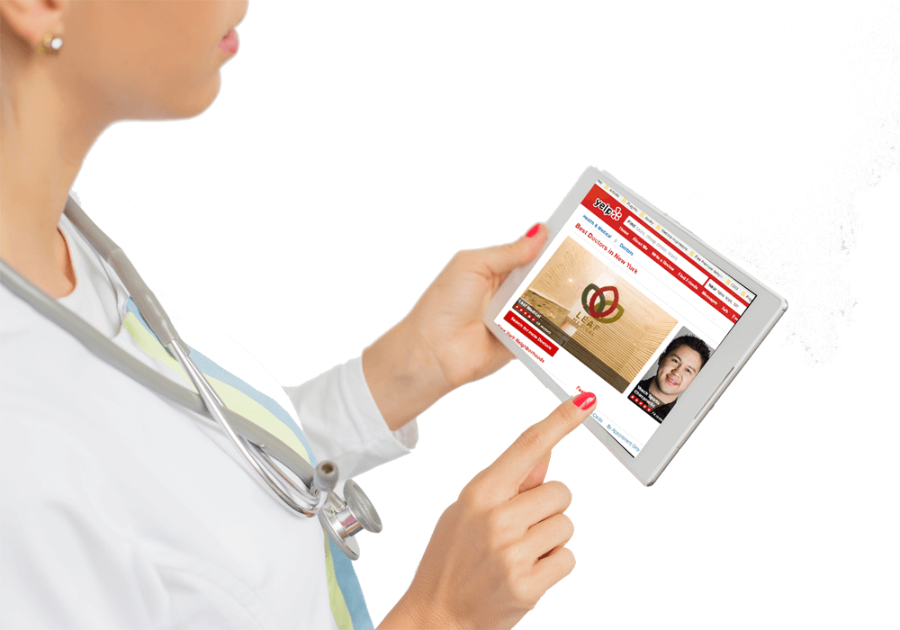 A healthcare professional holding a tablet with a medical website on screen, possibly researching information or reviewing a patient's medical history.