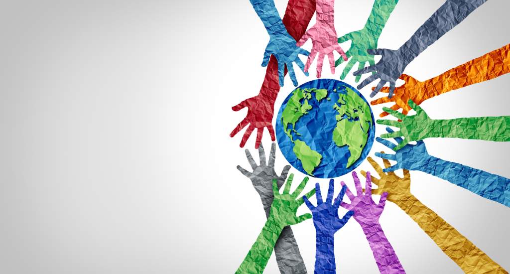 Colorful hands in unity around the globe, symbolizing how volunteering can boost your reputation through global diversity and cooperation.