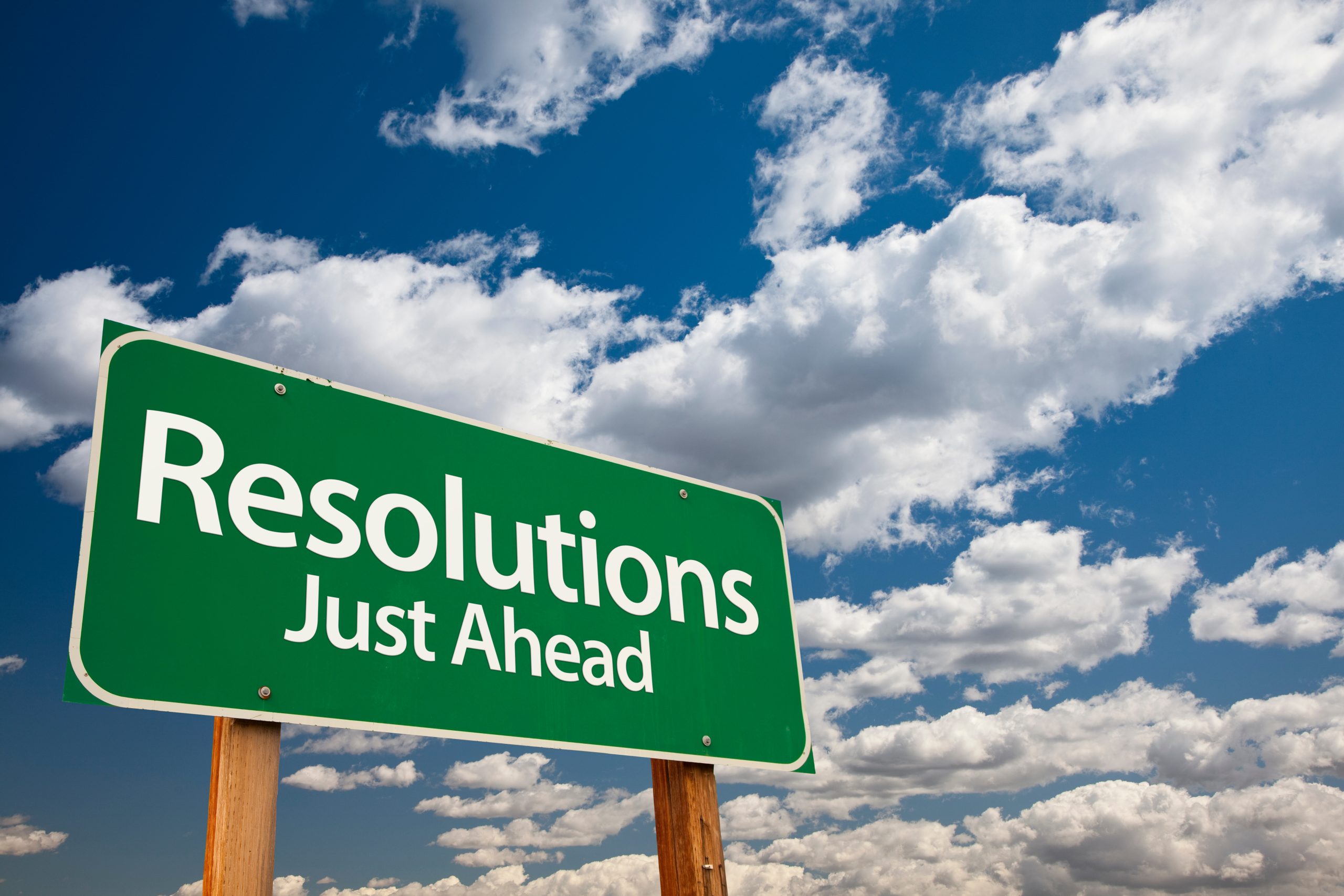 Green road sign against a blue sky with clouds reading 'renew your online reputation just ahead', symbolizing the onset of new beginnings and goals.