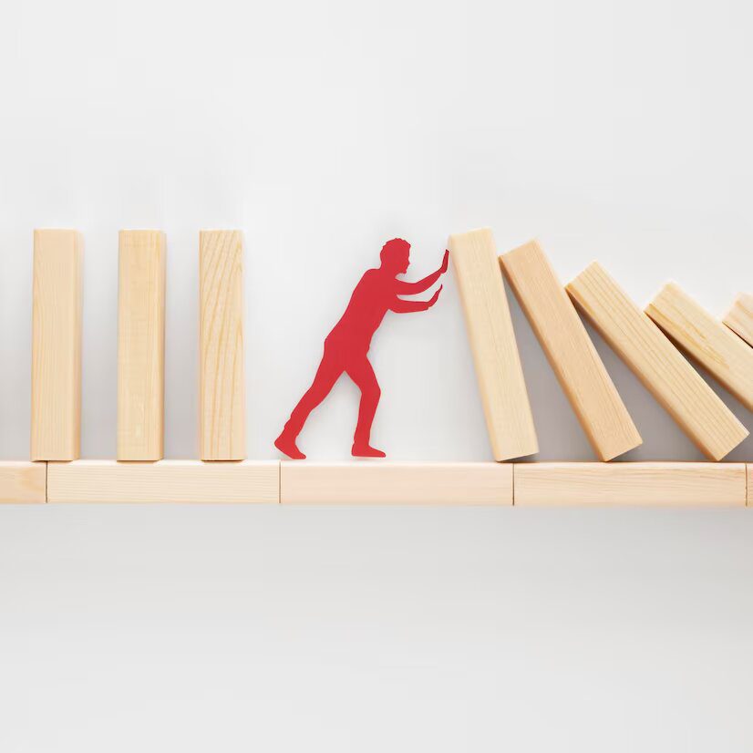 a man is trying to climb a set of wooden blocks.