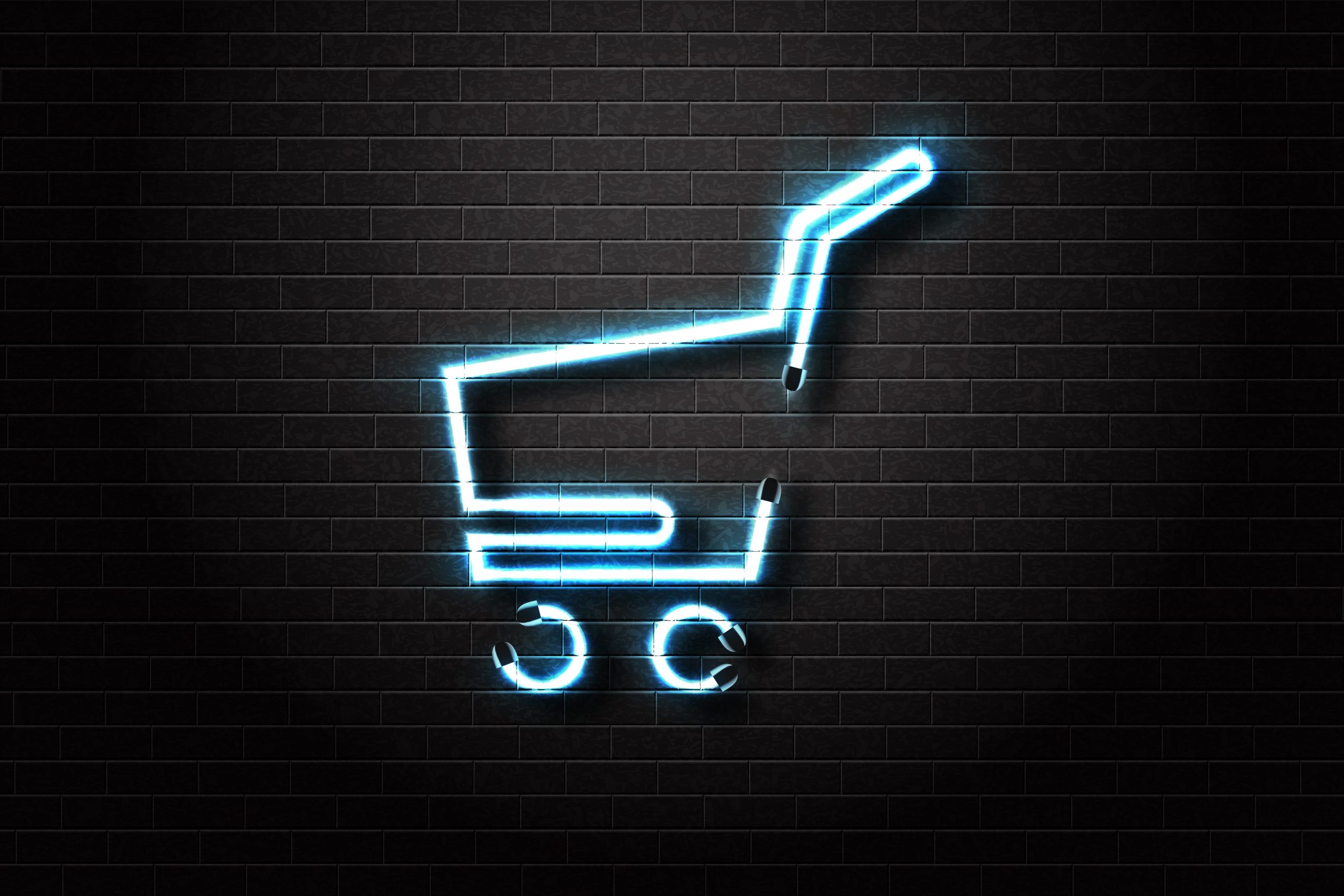 A shopping cart neon sign on a brick wall.