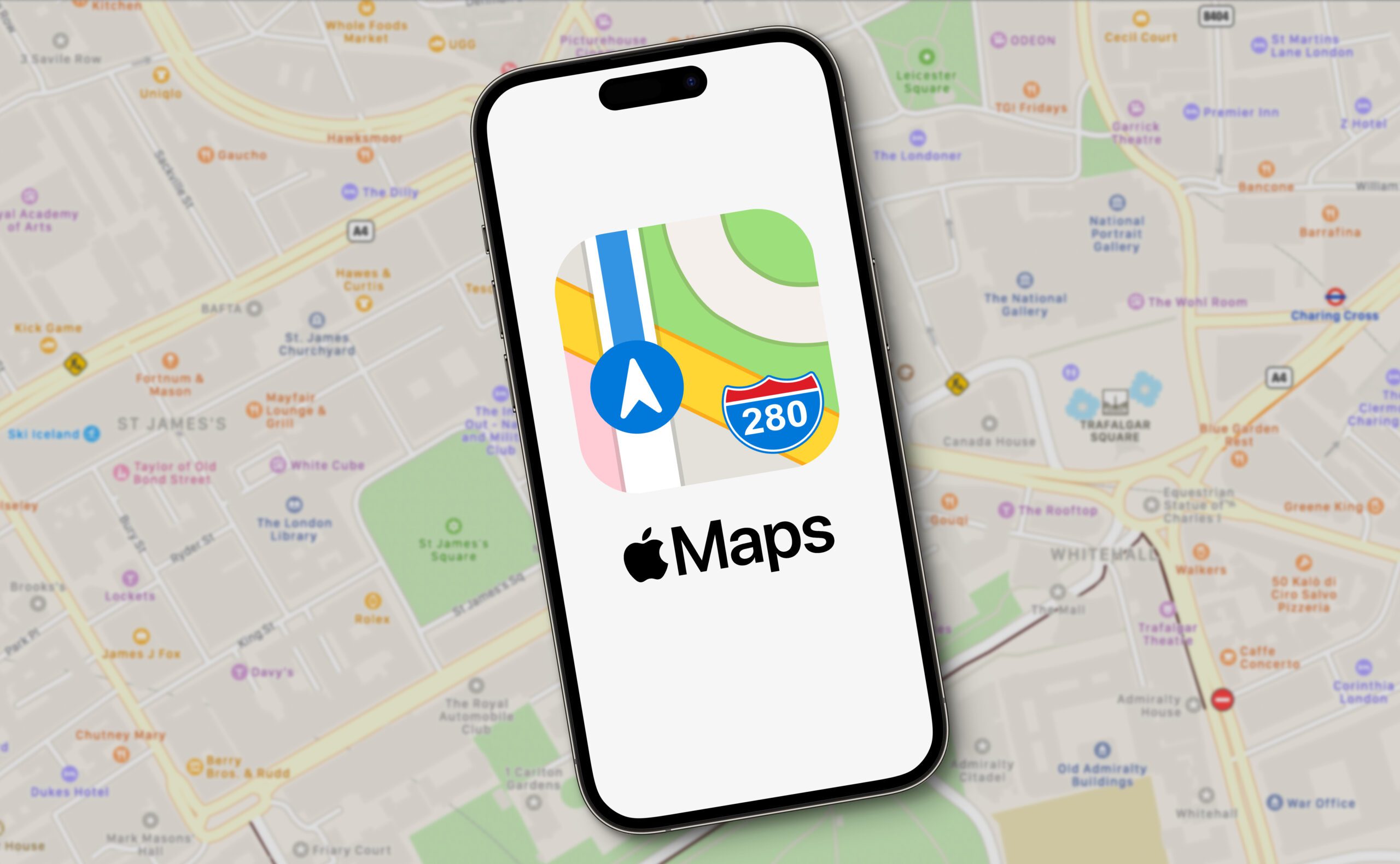 A smartphone displaying the Apple Maps app logo is placed on top of a physical map. The map background shows streets and landmarks in a city. The Apple Maps logo features a colorful road map icon with the number 280 and the word "Maps" beneath it.